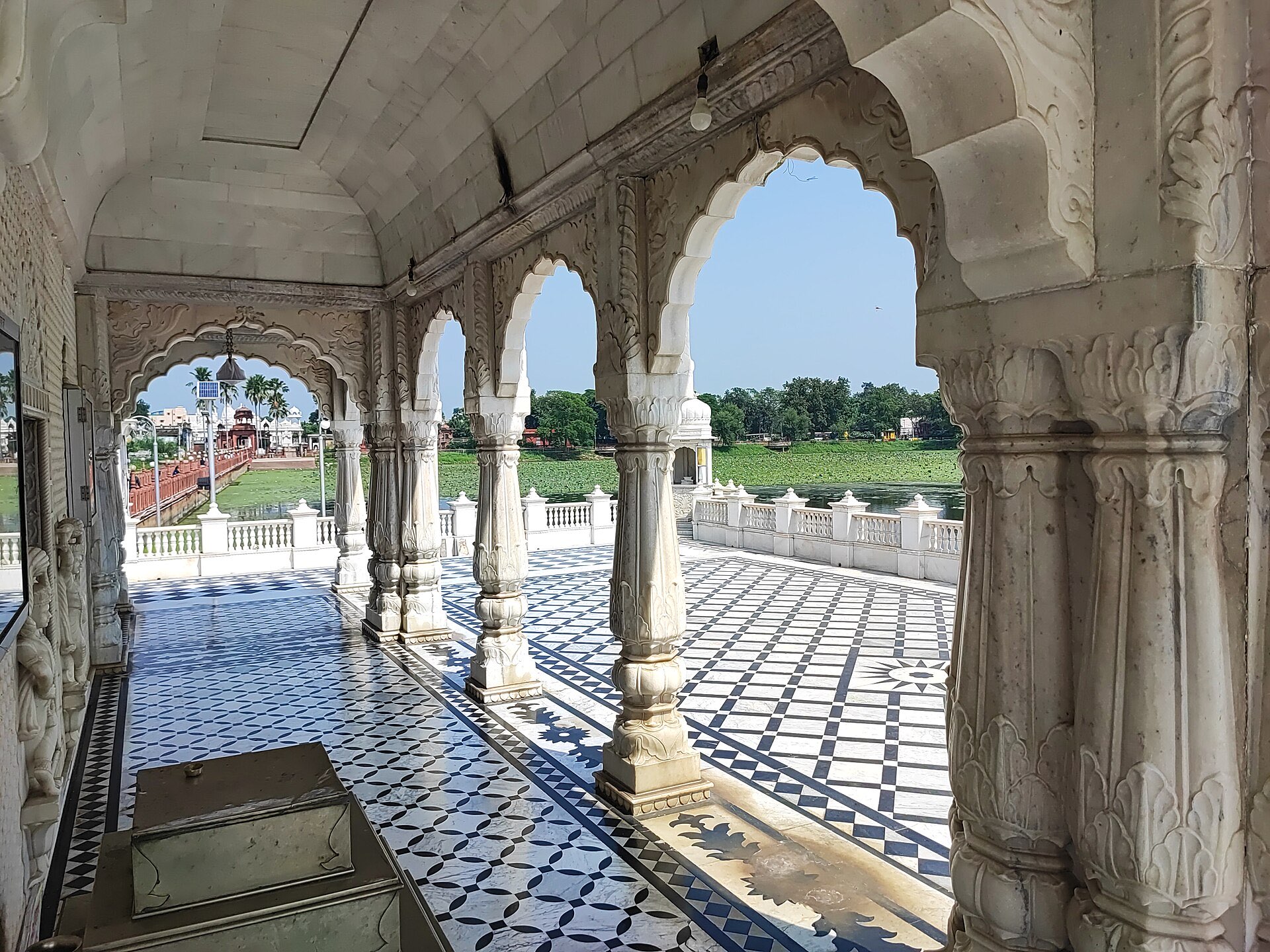 Carved white marble arches of the Jal Mandir at Pawapuri, looking out over the lotus lake