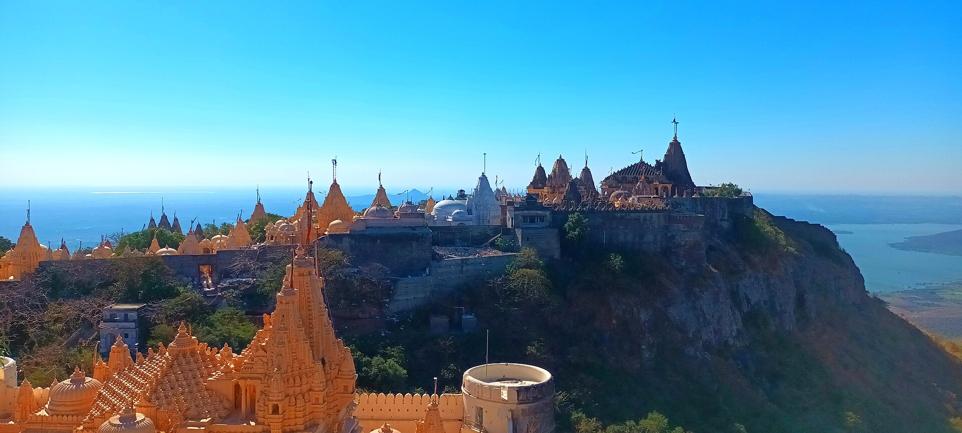 Panorama of the marble temple city of Palitana on Shatrunjaya hill, with the sea on the horizon