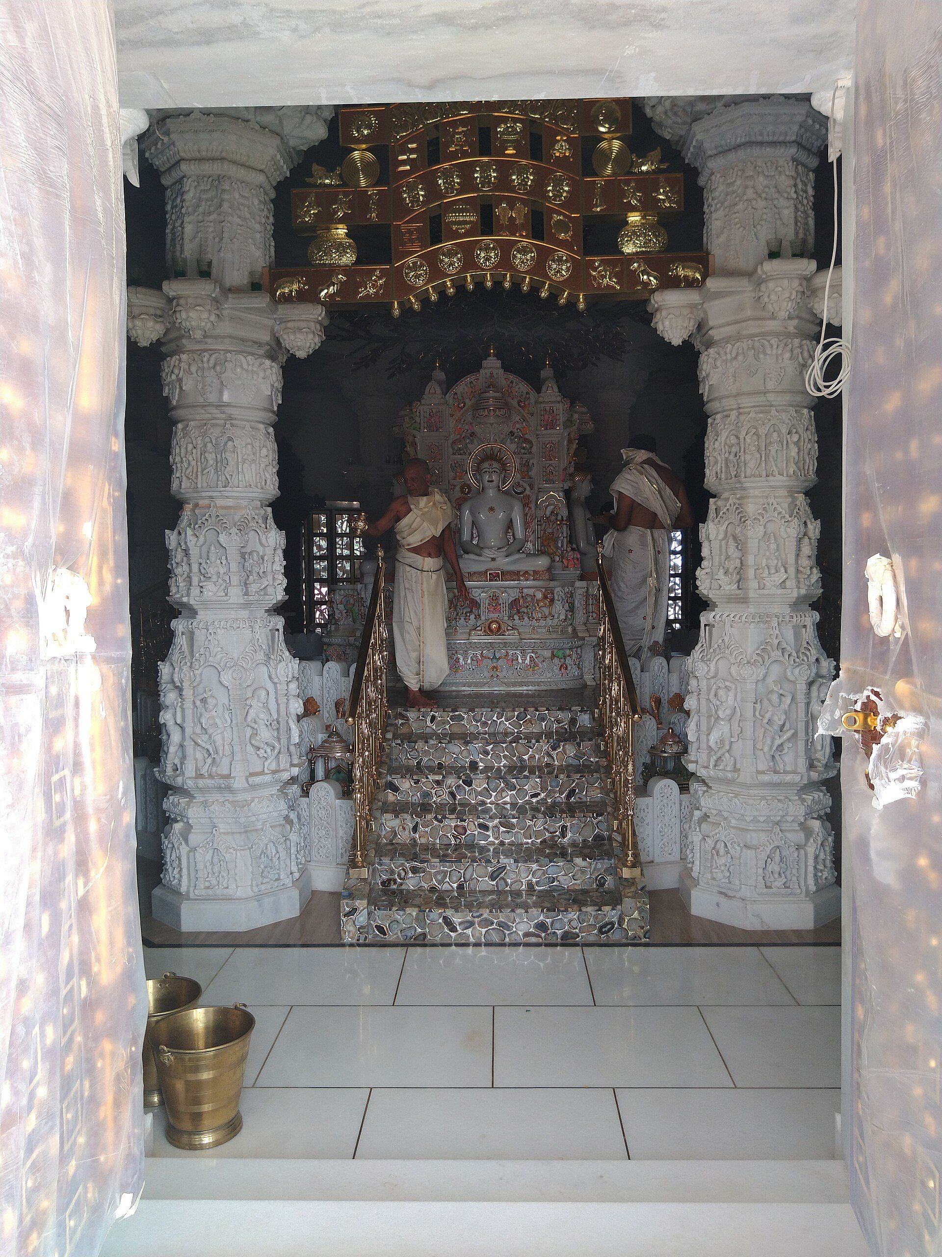 The Mahaveer idol enshrined between carved marble pillars at the Rijubalika temple, where he attained omniscience