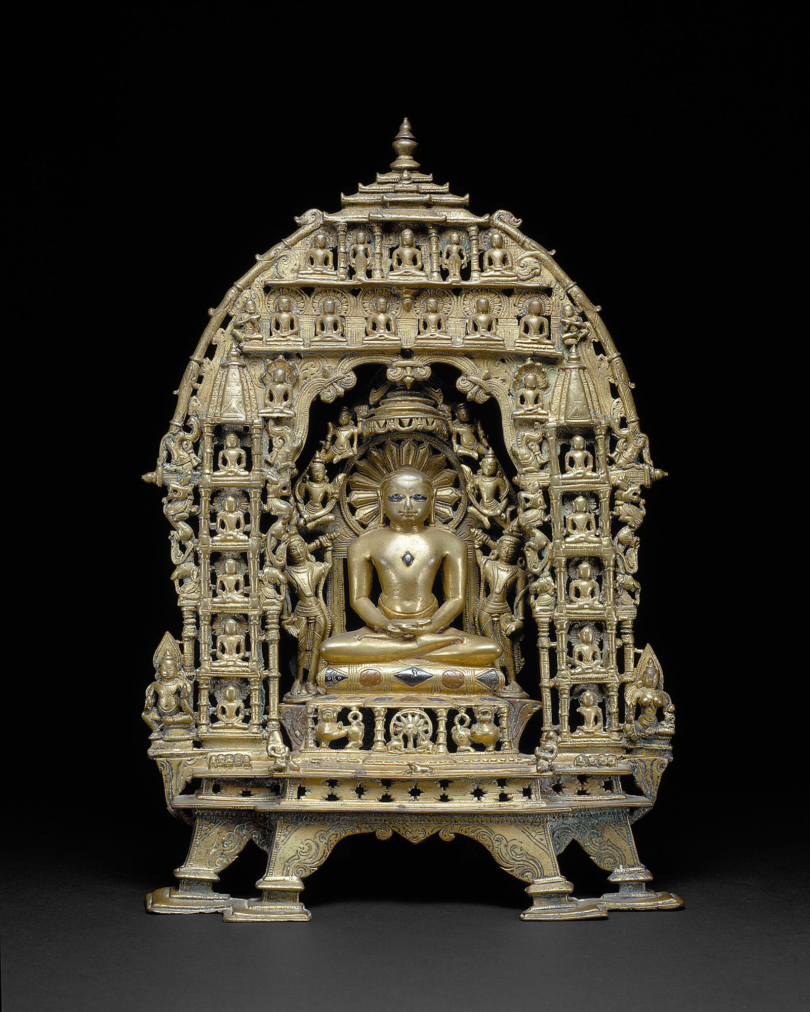 Bronze altarpiece of 1089 CE with the first Tirthankara Rishabhanatha enthroned, surrounded by smaller figures of the other Jinas